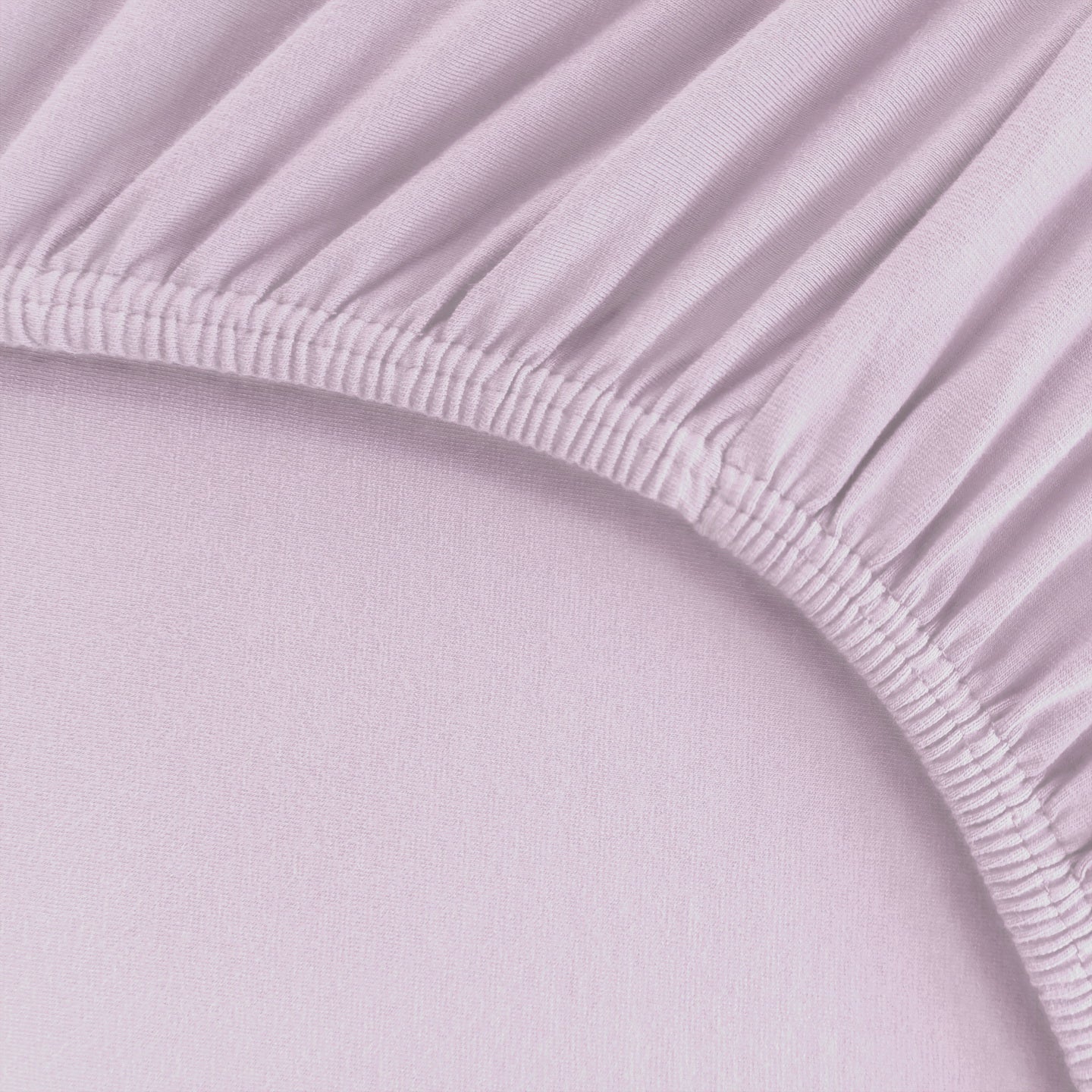 Detailaufnahme von einem Spannbetttuch für Boxspringbetten und hohe Matratzen mit starkem Rundumgummi in Hellviolett